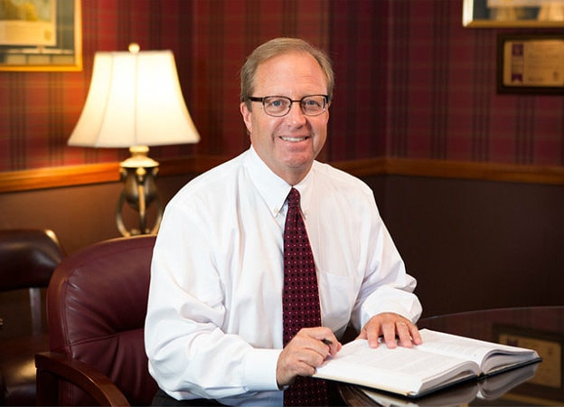 Workers Compensation Lawyer, Thomas Marchese, sitting at his desk in his office.