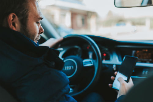 A man texting while driving