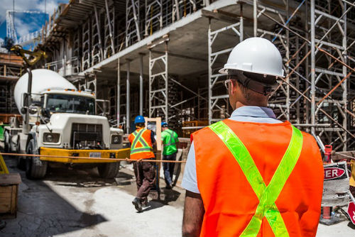 A group of construction workers working on a large building