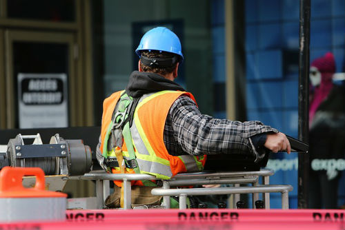 A man in a hard hat and vest working on the Columbus streets