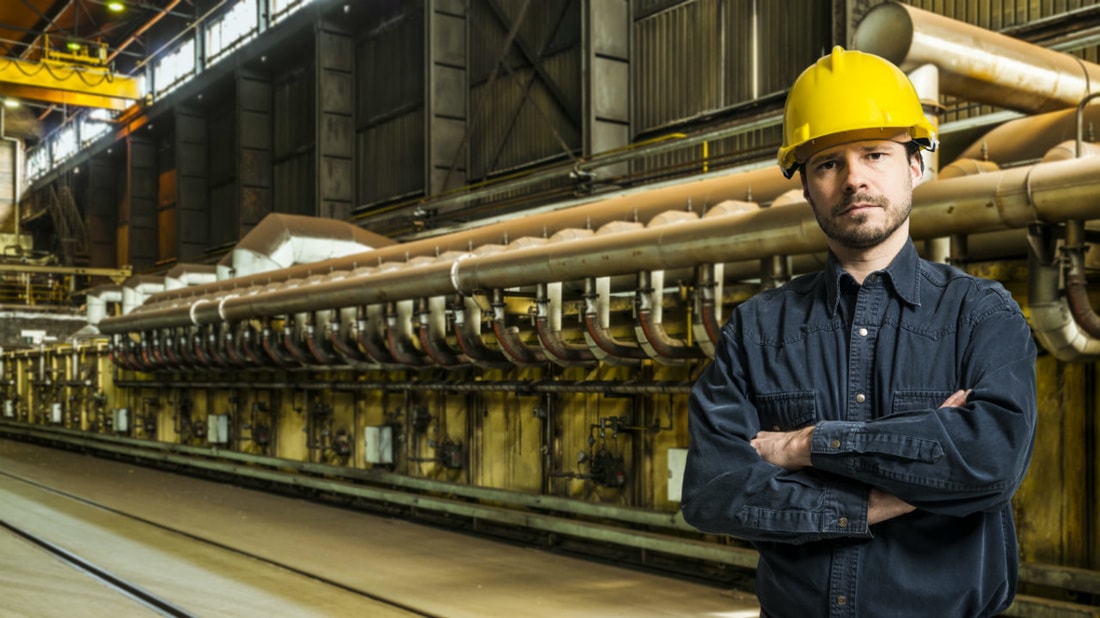man in hard hat standing in front of machinery man in hard hat standing in front of machinery