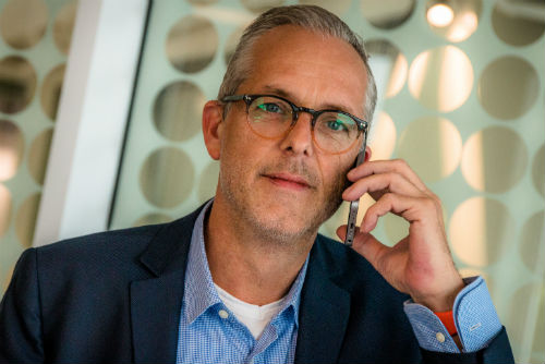 A man in a suit talking on his cellphone