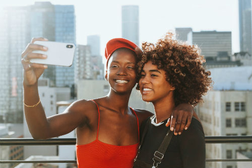 Two people smiling for a selfie on a rooftop in Columbus.