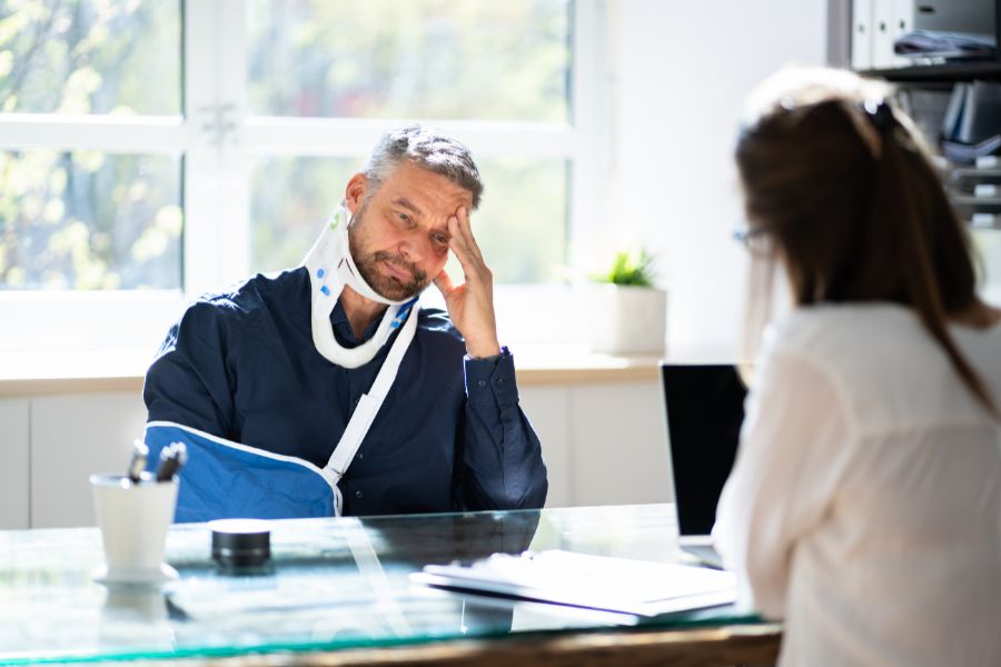 An injured worker talking to a workers' comp lawyer