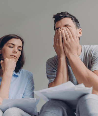 denied-claim A stressed couple looking over a denied workers' comp claim