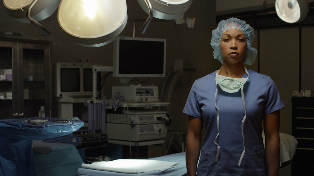An injured healthcare worker standing in an operating room