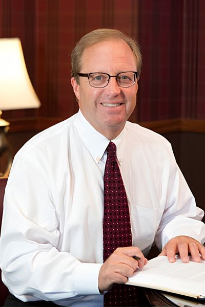 Columbus Workers comp attorney, Tom Marchese, sitting at his desk in his office in Dublin Ohio